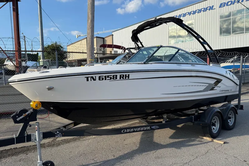 Slide: The Image of 2022 Chaparral 21 SSi boat on trailer, parked outside a Chaparral dealership. - 0