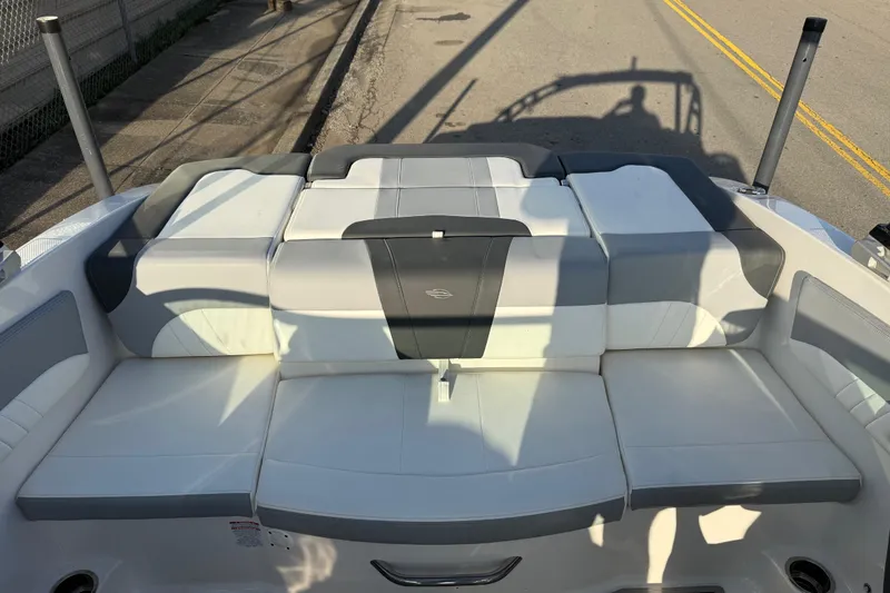 Slide: The Image of 2022 Chaparral 21 SSi boat interior with cushioned seating and sleek design. - 11