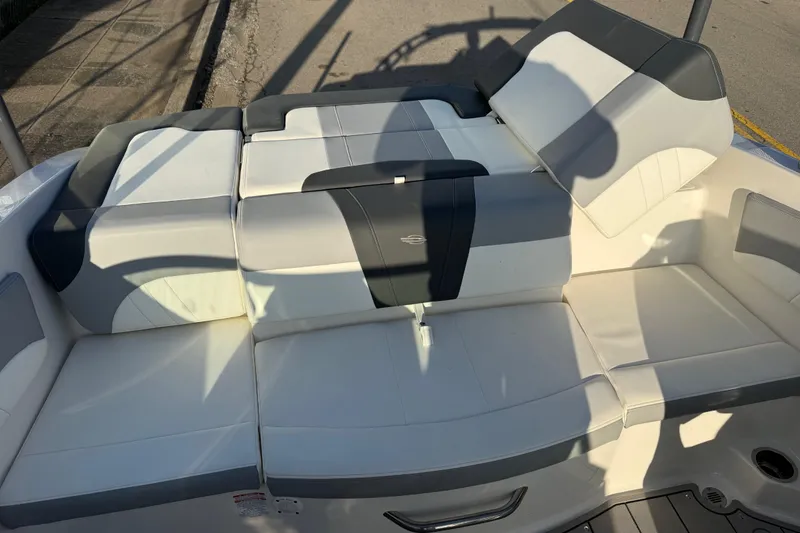 Slide: The Image of 2022 Chaparral 21 SSi boat interior with white and gray seating. - 12