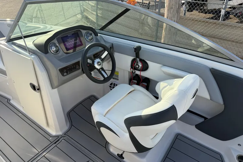 Slide: The Image of 2022 Chaparral 21 SSi boat interior with steering wheel and dashboard controls. - 15