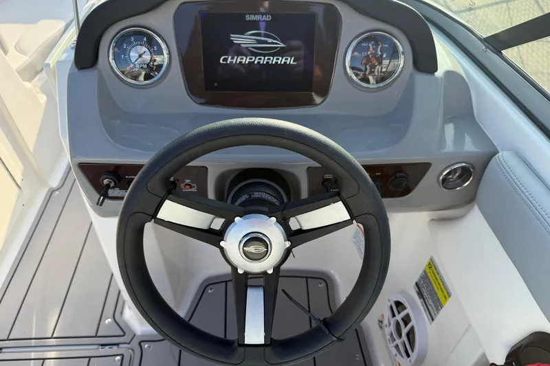 Slide: The Image of Steering wheel and dashboard of 2022 Chaparral 21 SSi boat with Simrad display. - 16
