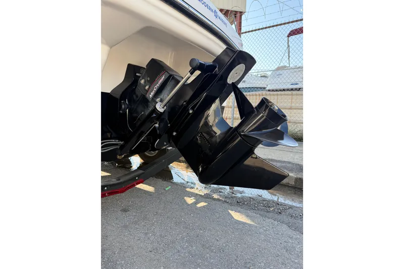 Slide: The Image of 2022 Chaparral 21 SSi boat with MerCruiser outdrive, parked on concrete. - 25