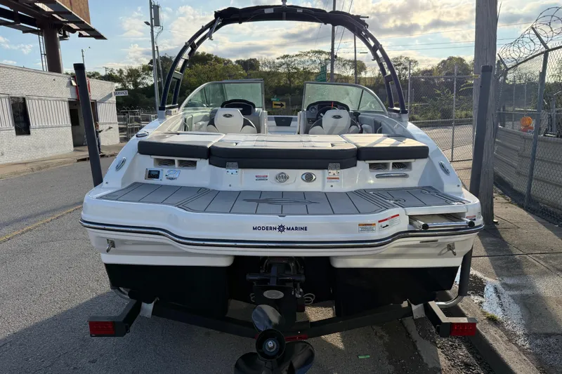 Slide: The Image of 2022 Chaparral 21 SSi boat, rear view, parked on trailer in urban setting. - 3