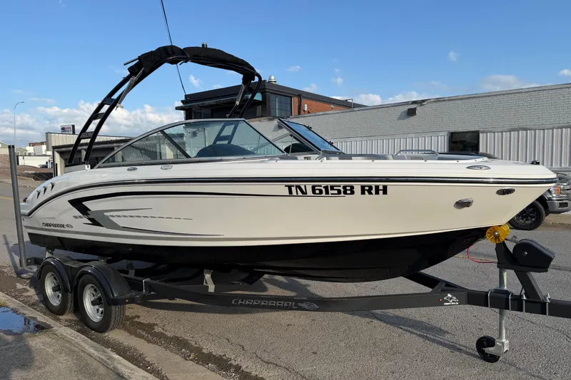 Slide: The Image of 2022 Chaparral 21 SSi boat on trailer, parked outdoors. - 4