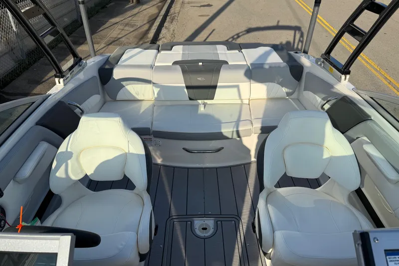 Slide: The Image of 2022 Chaparral 21 SSi boat interior with white seating and sleek design. - 7