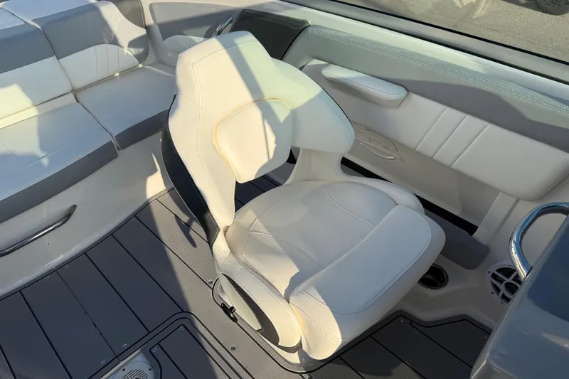 Slide: The Image of 2022 Chaparral 21 SSi boat interior with white seating and modern design. - 8