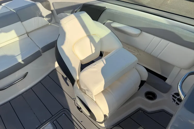 Slide: The Image of 2022 Chaparral 21 SSi boat interior with white leather seating and modern design. - 9