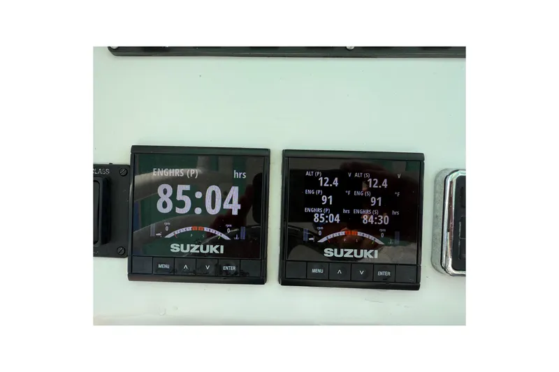 Slide: The Image of Suzuki engine display on 2019 Twin Vee 26 Center Console boat, showing engine hours and metrics. - 15