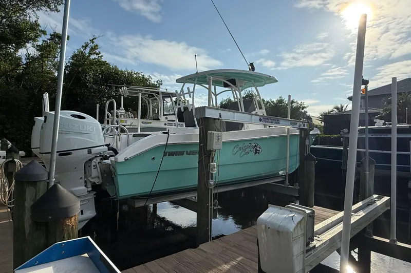 Slide: The Image of 2019 Twin Vee 26 Center Console boat docked with Suzuki engines. - 3