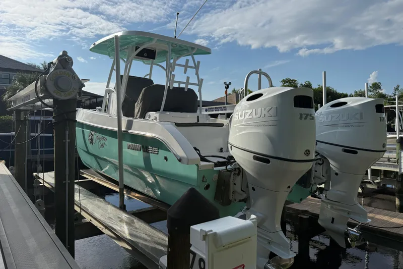 Slide: The Image of 2019 Twin Vee 26 Center Console boat with dual Suzuki 175 engines on a lift. - 4