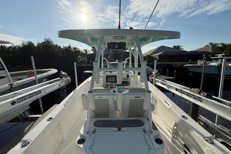 Slide: The Image of 2019 Twin Vee 26 Center Console boat docked under a sunny sky. - 6