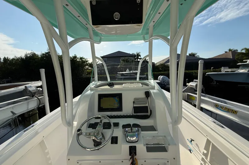 Slide: The Image of 2019 Twin Vee 26 Center Console boat interior with steering wheel and navigation display. - 7