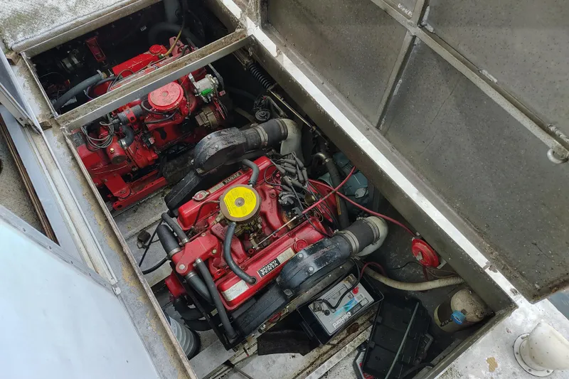 Slide: The Image of Engine compartment of a 1981 Lazy Days 50 boat, featuring dual red engines. - 15