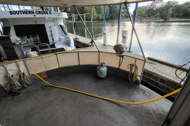 Slide: The Image of Boat deck with ropes and gas cylinder, docked near calm water, Lazy Days 1981 model. - 19