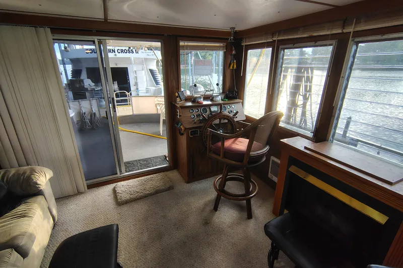 Slide: The Image of Interior of 1981 Lazy Days 50 boat with helm, windows, and seating area. - 25