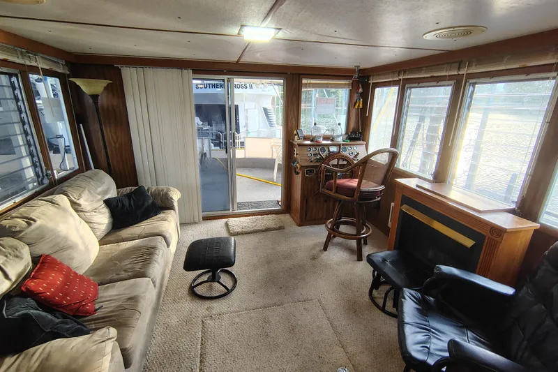 Slide: The Image of Interior of a 1981 Lazy Days 50 houseboat with cozy seating and helm station. - 26