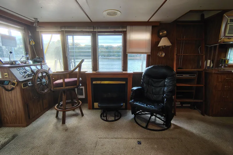 Slide: The Image of Interior of a 1981 Lazy Days 50 boat with steering wheel and seating area. - 28