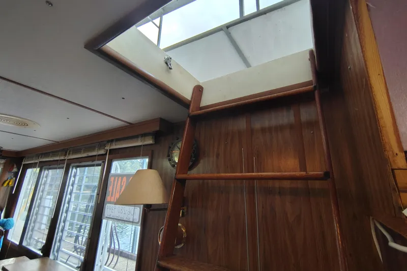 Slide: The Image of Interior of 1981 Lazy Days 50 boat with wooden ladder and skylight. - 29