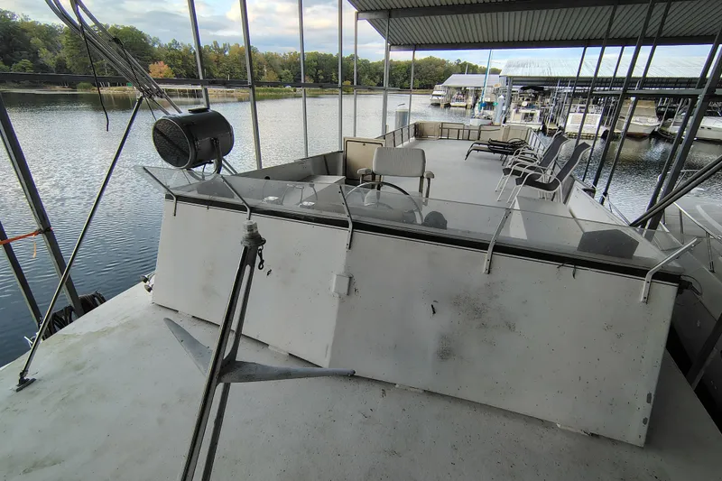 Slide: The Image of 1981 Lazy Days 50 houseboat with spacious deck, docked at a marina. - 35
