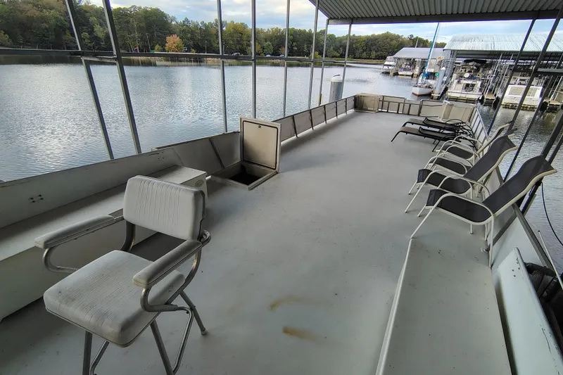 Slide: The Image of Upper deck of 1981 Lazy Days 50 houseboat with chairs overlooking marina. - 37