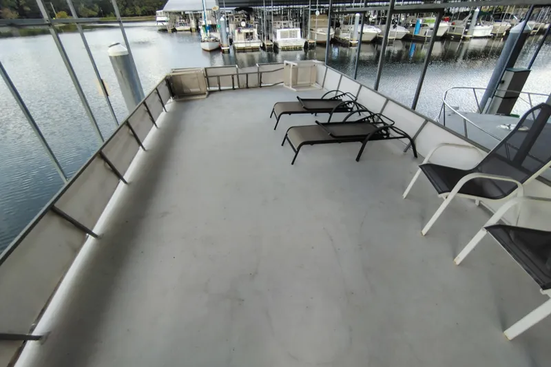 Slide: The Image of Upper deck of 1981 Lazy Days 50 houseboat with lounge chairs and marina view. - 38
