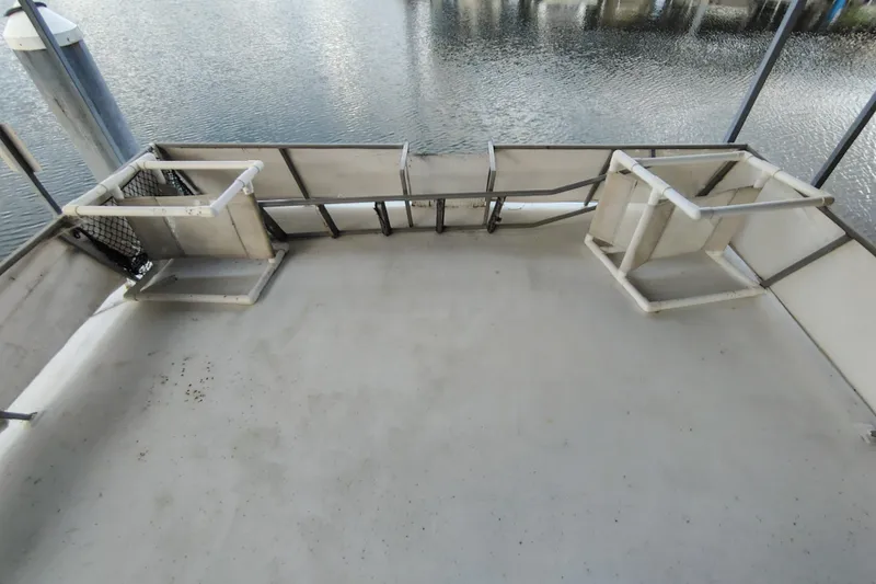 Slide: The Image of Empty deck of 1981 Lazy Days 50 boat overlooking calm water. - 39