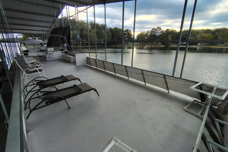 Slide: The Image of Covered deck of 1981 Lazy Days 50 houseboat with lounge chairs overlooking serene lake. - 40