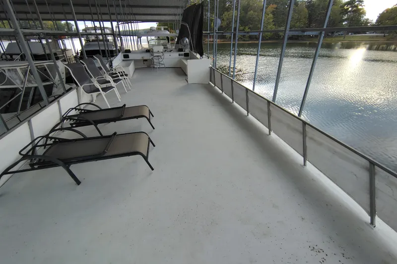 Slide: The Image of Spacious deck of 1981 Lazy Days 50 houseboat with lounge chairs and scenic lake view. - 41