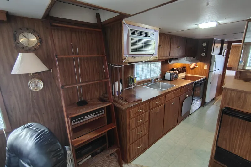 Slide: The Image of Interior of 1981 Lazy Days 50 houseboat with wood paneling and compact kitchen. - 43
