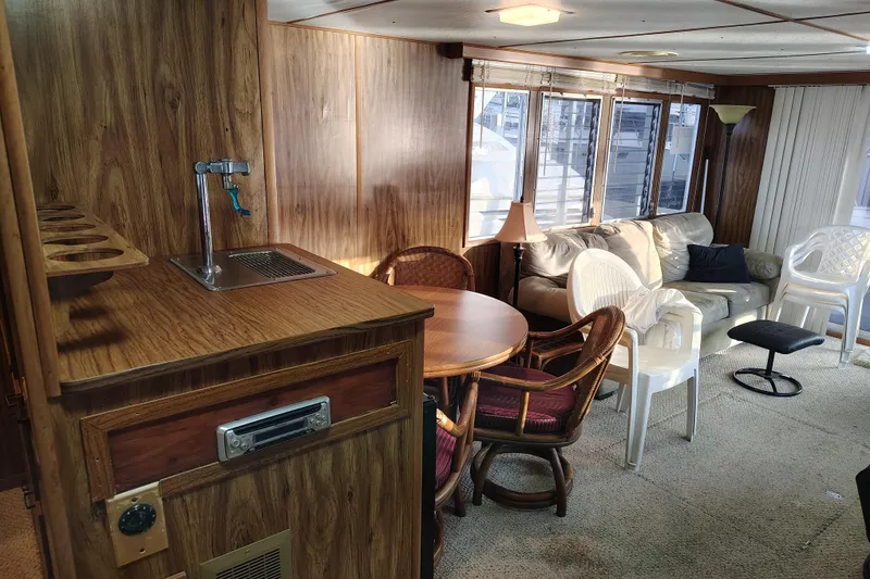 Slide: The Image of Interior of 1981 Lazy Days 50 houseboat with wood paneling, seating, and dining area. - 45