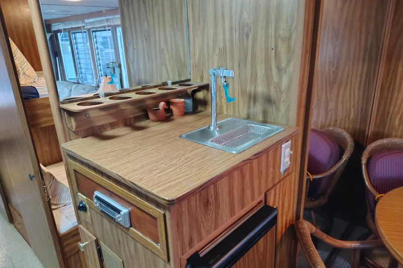 Slide: The Image of Vintage 1981 Lazy Days 50 interior with wood paneling, sink, and cozy seating area. - 46