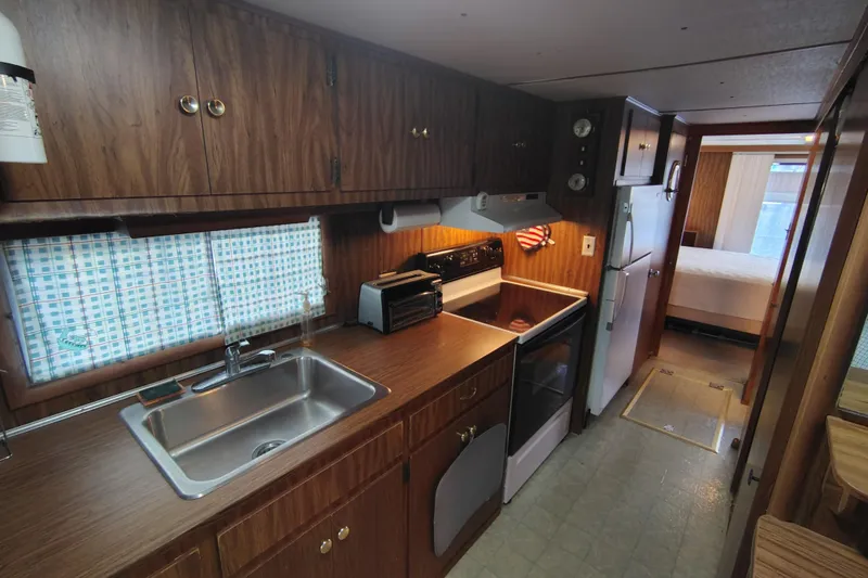 Slide: The Image of 1981 Lazy Days 50 RV kitchen interior with wood cabinets and appliances. - 47