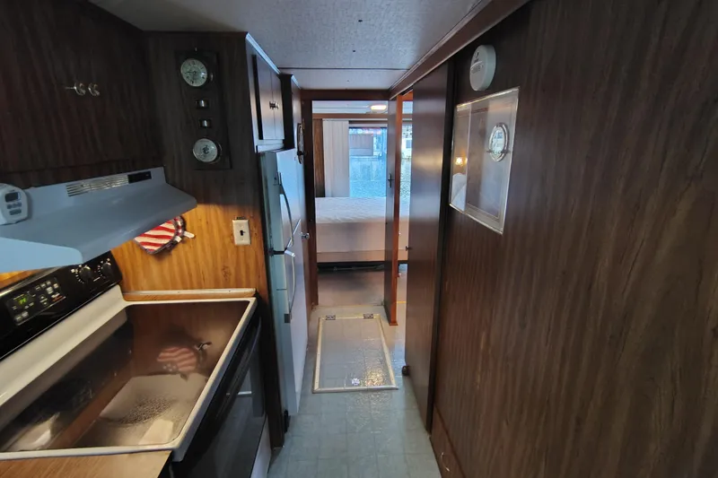 Slide: The Image of Interior of a 1981 Lazy Days 50 houseboat with kitchen and hallway view. - 49