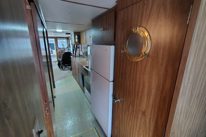 Slide: The Image of Interior of 1981 Lazy Days 50 boat with kitchen and wooden decor. - 50