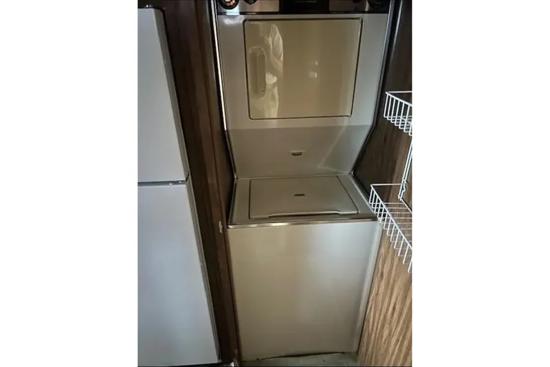 Slide: The Image of Vintage 1981 Lazy Days 50 RV interior with stacked washer and dryer unit. - 51
