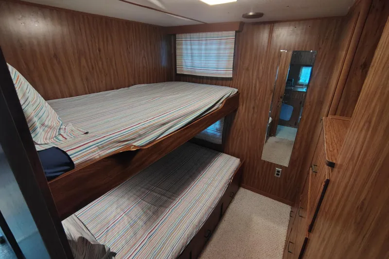 Slide: The Image of Cozy 1981 Lazy Days 50 RV interior with wood paneling and bunk beds. - 53