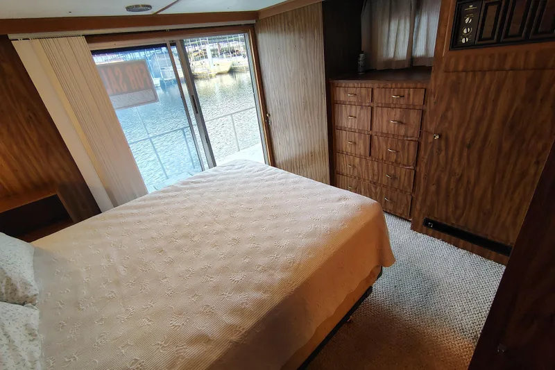 Slide: The Image of Cozy bedroom in 1981 Lazy Days 50 houseboat with wood paneling and water view. - 57