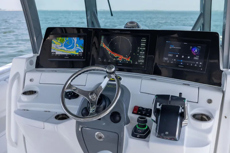 Slide: The Image of Helm of 2026 HCB 42 Lujo boat with advanced navigation displays and controls. - 12
