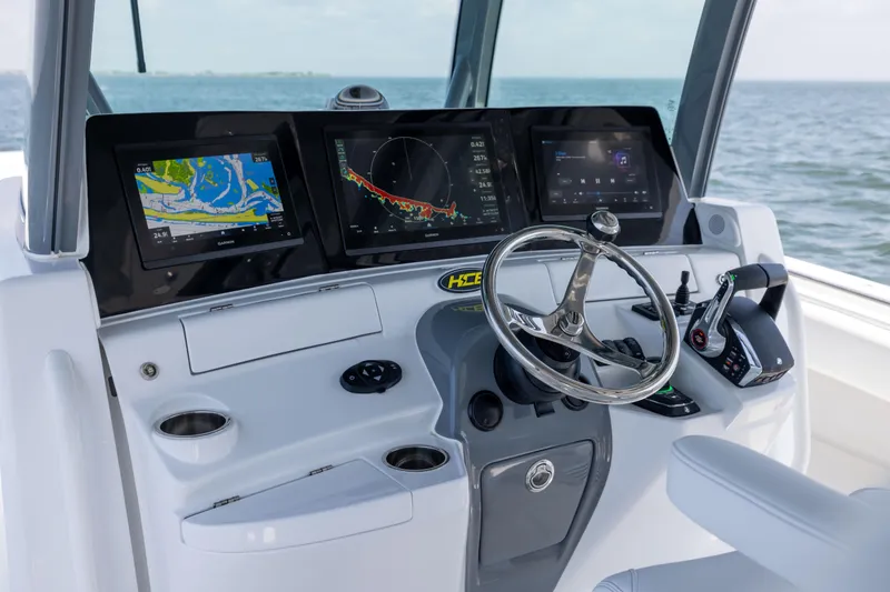 Slide: The Image of 2026 HCB 42 Lujo boat dashboard with advanced navigation screens and controls. - 13