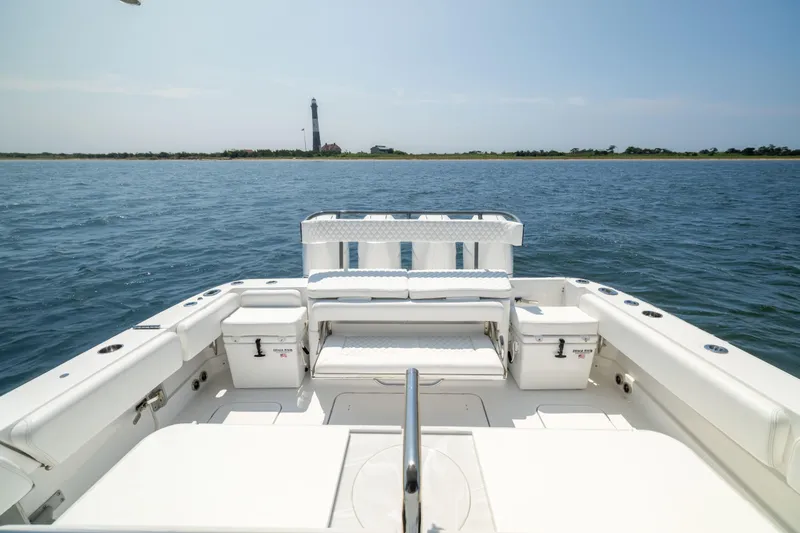 Slide: The Image of 2026 HCB 42 Lujo boat interior with ocean view and distant lighthouse. - 16