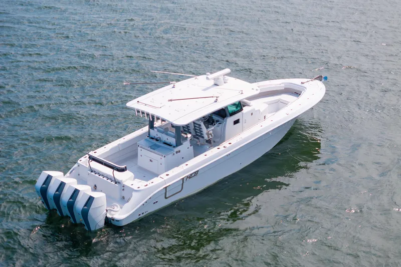 Slide: The Image of 2026 HCB 42 Lujo boat on open water, featuring sleek design and multiple engines. - 19