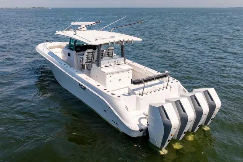 Slide: The Image of 2026 HCB 42 Lujo boat with four engines cruising on open water. - 2