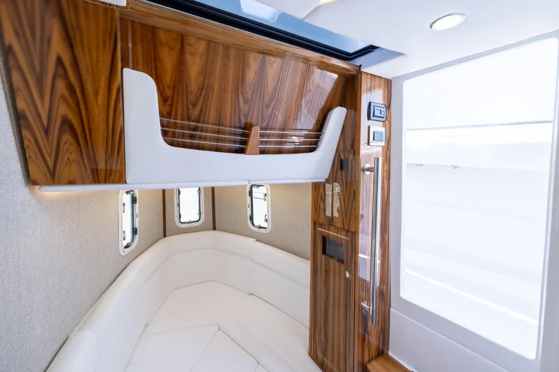 Slide: The Image of Luxurious interior of 2026 HCB 42 Lujo boat with wood accents and white seating. - 24