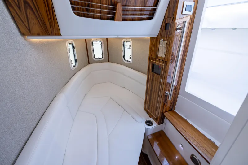 Slide: The Image of Luxurious interior of 2026 HCB 42 Lujo boat with elegant wood accents and plush seating. - 25