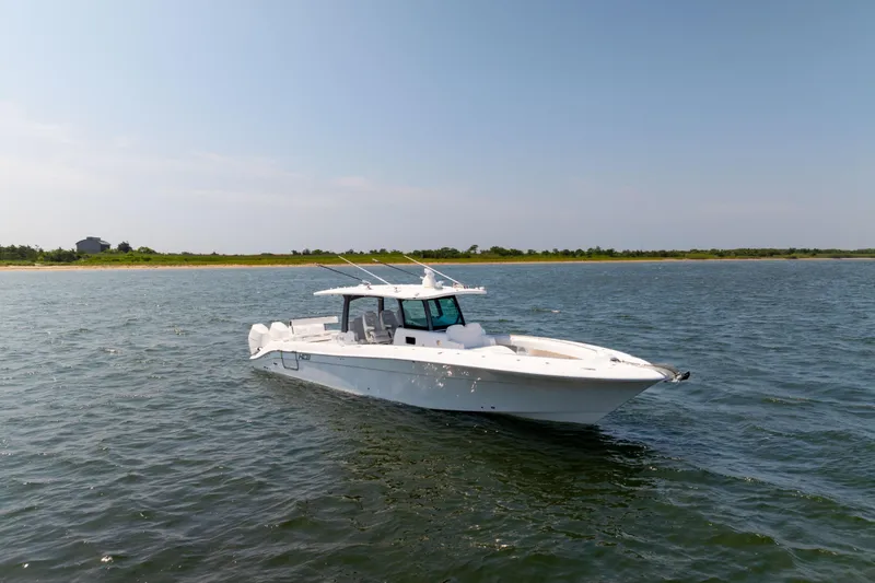 Slide: The Image of 2026 HCB 42 Lujo boat cruising on calm waters under a clear sky. - 29