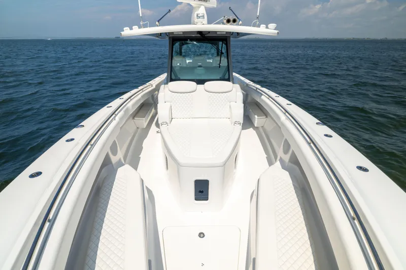 Slide: The Image of 2026 HCB 42 Lujo boat on open water, showcasing sleek design and luxury seating. - 32