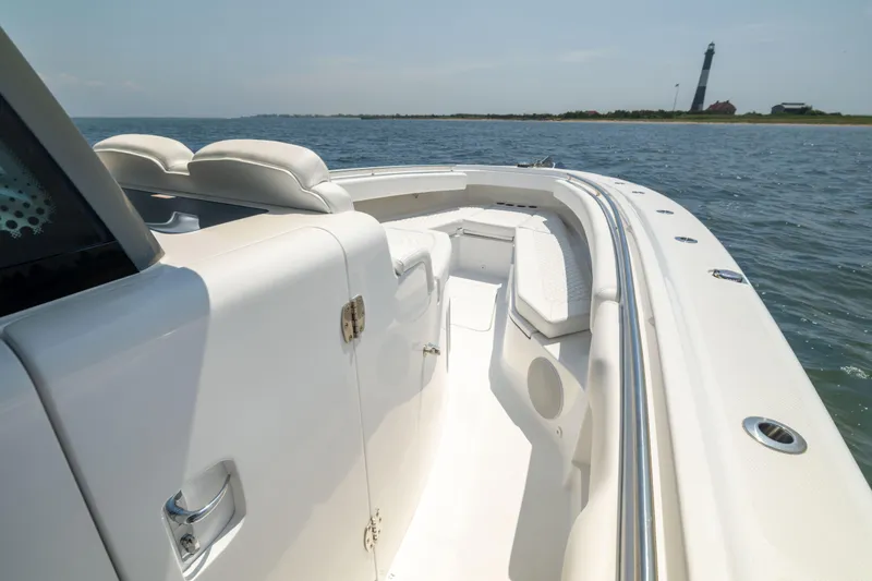 Slide: The Image of Luxury HCB 42 Lujo boat cruising near a lighthouse, 2026 model. - 33