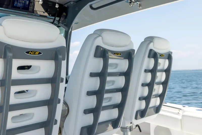 Slide: The Image of Luxury seating on 2026 HCB 42 Lujo boat, featuring sleek design and ocean backdrop. - 34