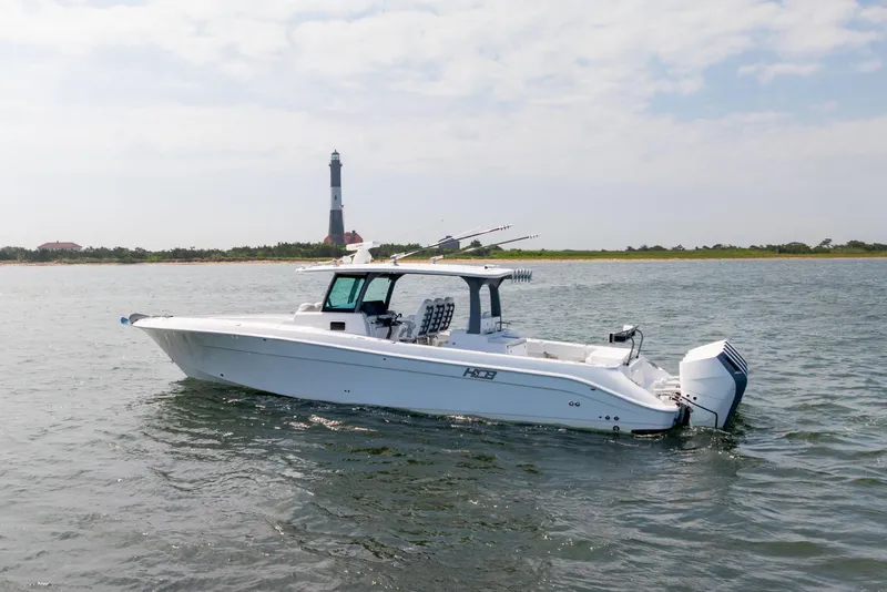 Slide: The Image of 2026 HCB 42 Lujo boat on water near a lighthouse under a cloudy sky. - 4