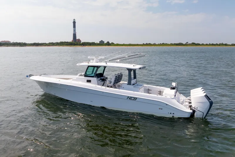 Slide: The Image of 2026 HCB 42 Lujo boat on water near a lighthouse. - 6